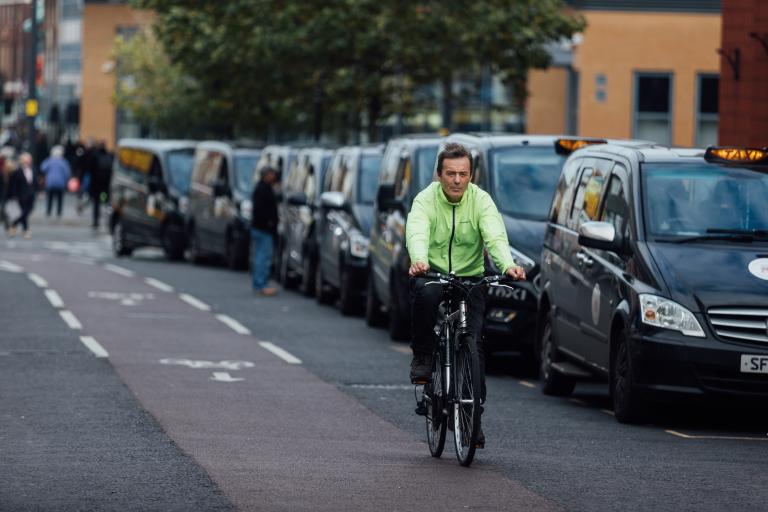 Man cycling using cycle path in Leicester.