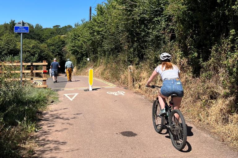 Cyclist and pedestrians using a path in a rural location