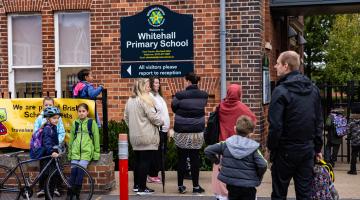 Children and parents outside Whitehall Primary School, Bristol.