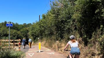 Cyclist and pedestrians using a path in a rural location