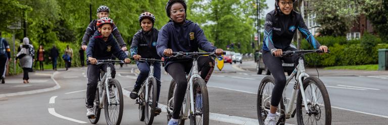 Teens cycling on a segregated cycle path in Binley, Coventry