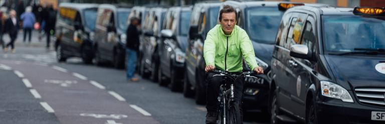 Man cycling using cycle path in Leicester.