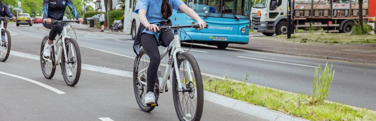 Teen children cycling on a segregated cycle path in Binley, Coventry